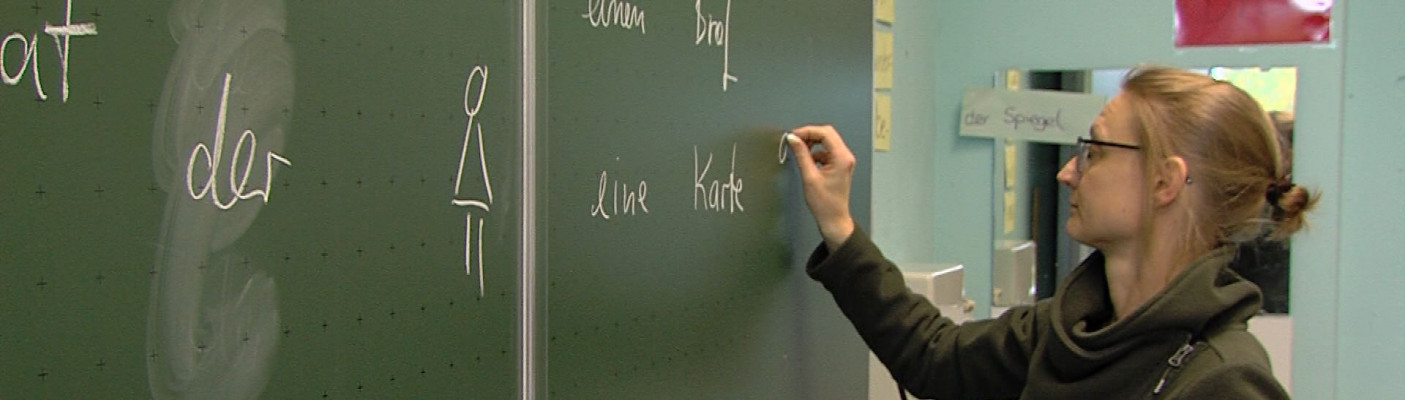 Lehrerin schreibt an der Tafel | Bildquelle: RTF.1